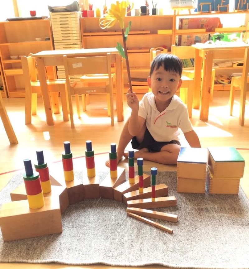 Child concentrating on hands-on Montessori learning materials